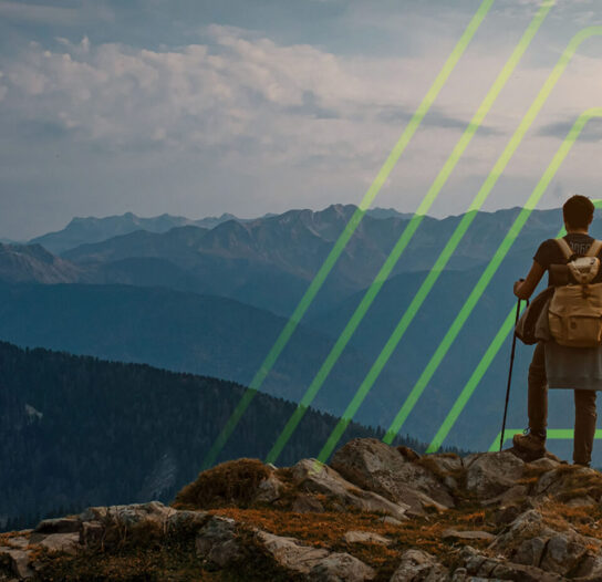 Hiker with a backpack standing on a rocky summit, overlooking a layered mountain range under a cloudy sky with a lime-green geometric overlay.