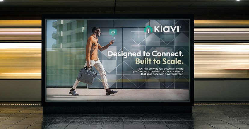 motion-market-expression-img-3 | HIFI Agency | Financial Marketing Agency Billboard in a transit station shows a man in an orange jacket walking with a briefcase; ad reads 'Designed to Connect. Built to Scale.' Kiavi logo.